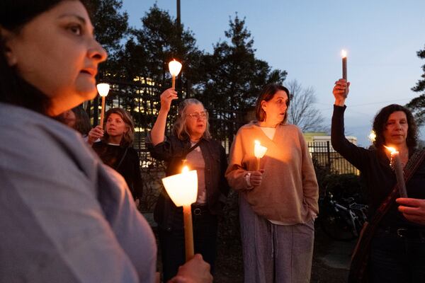 People gather for a candlelight vigil in support of the Centers for Disease Control and Prevention in front of its headquarters in Atlanta, Friday, March 28, 2025. (AP Photo/Ben Gray)
