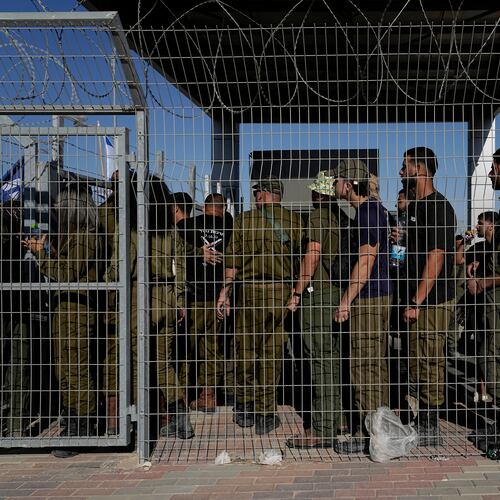 FILE - Israeli soldiers gather at the gate to the Sde Teiman military base, as people protest in support of soldiers being questioned for detainee abuse, July 29, 2024. (AP Photo/Tsafrir Abayov, File)