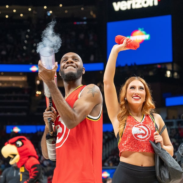Calvin Brown put some muscle into launching fan freebies with the T-shirt cannon. (Courtesy of Atlanta Hawks)