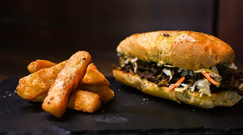 Taking inspiration from a Cuban sandwich, Zeke's offers one with Haitian components: epis-marinated pork and brisket, pikliz and an epis aioli. Courtesy of Zeke's Kitchen and Bar