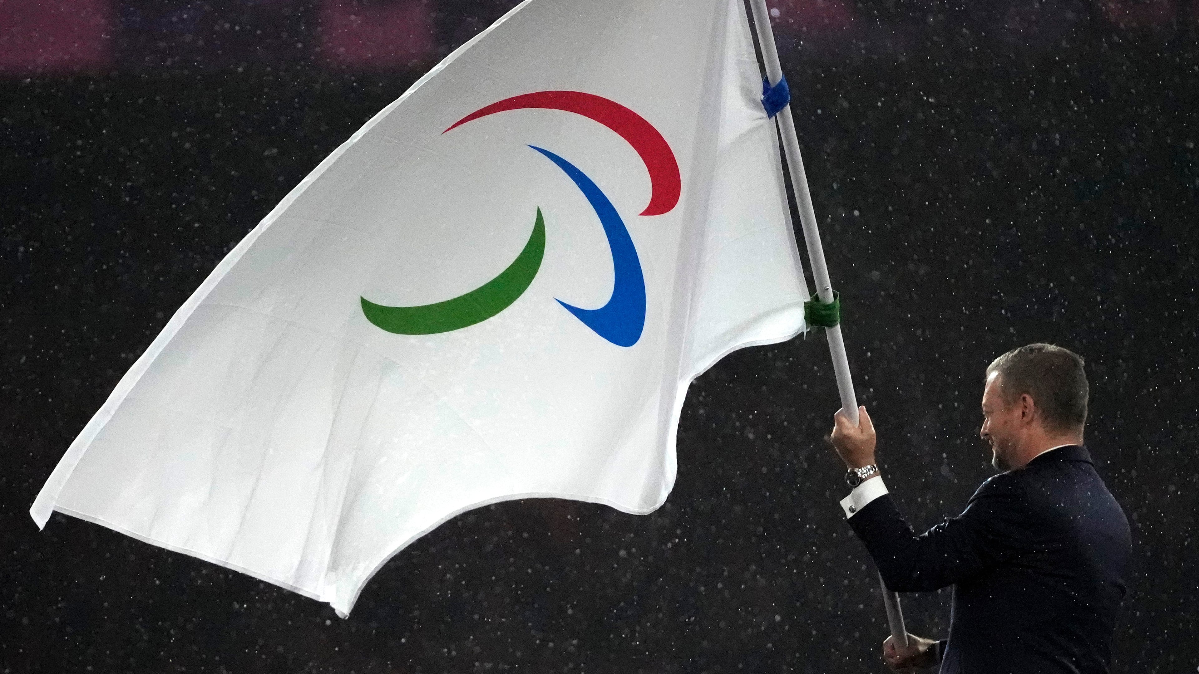 FILE - President of the International Paralympic Committee Andrew Parsons passes the Paralympic flag to Mayor of Los Angeles Karen Bass, not in photo, after receiving it from Mayor of Paris Anne Hidalgo, not in photo, during the closing ceremony of the 2024 Paralympics, Sunday, Sept. 8, 2024, in Paris, France. (AP Photo/Michel Euler, File)