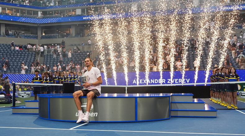 Alexander Zverev, of Germany, holds his trophy after winning the men's singles final of the U.S. Open tennis championships against Ben Shelton, of the United States, Sunday, Sept. 13, 2026, in New York. (AP Photo/Frank Franklin II)