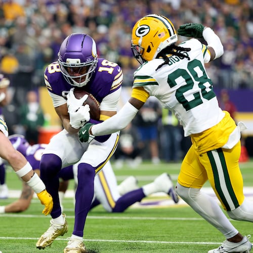 Minnesota Vikings wide receiver Justin Jefferson (18) is tackled by Green Bay Packers safety Evan Williams (33) and cornerback Trevon Diggs (28) after catching a pass during the first half of an NFL football game, Sunday, Jan. 4, 2026, in Minneapolis. (AP Photo/Ellen Schmidt)