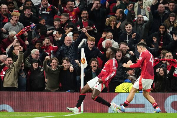 Manchester United's Kobbie Mainoo celebrates after scoring his side's fourth goal during the Europa League quarter final second leg soccer match between Manchester United and Olympique Lyon in Manchester, Britain, Thursday, April 17, 2025. (AP Photo/Jon Super)