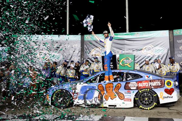 Driver Chase Elliott (9) celebrates in Victory Lane after winning a NASCAR Cup Series auto race, Saturday, June 28, 2025, in Hampton, Ga. (AP Photo/Butch Dill)