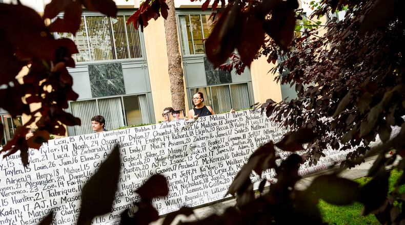 Lennon Torres of Heat Initiative holds a banner with names of young people who advocates say died as a result of social media outside the Ronald V. Dellums Federal Building and U.S. Courthouse on Tuesday, Aug. 18, 2026, in Oakland, Calif. (AP Photo/Noah Berger)