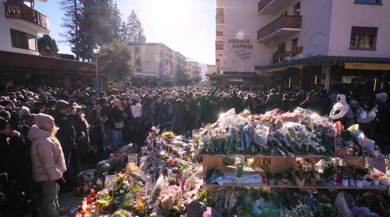 People gather during a memorial procession in Crans-Montana, Swiss Alps, Switzerland, Sunday, Jan. 4, 2026, after a devastating fire in Le Constellation bar left dead and injured during the New Year's celebrations. (AP Photo/ Antonio Calanni)