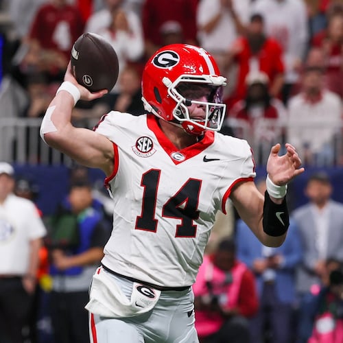 Georgia quarterback Gunner Stockton throws his first touchdown to Roderick Robinson II (not pictured) against Alabama during the first quarter of the SEC Championship game at Mercedes-Benz Stadium, Saturday, Dec. 6, 2025, in Atlanta. (Jason Getz/AJC)