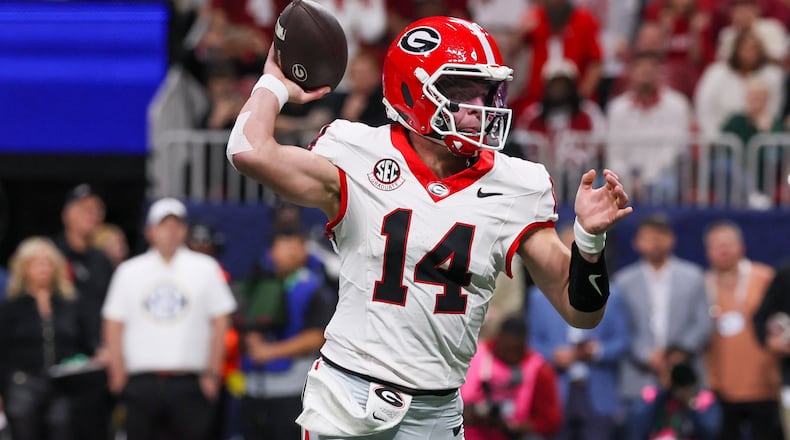 Georgia quarterback Gunner Stockton throws his first touchdown to Roderick Robinson II (not pictured) against Alabama during the first quarter of the SEC Championship game at Mercedes-Benz Stadium, Saturday, Dec. 6, 2025, in Atlanta. (Jason Getz/AJC)