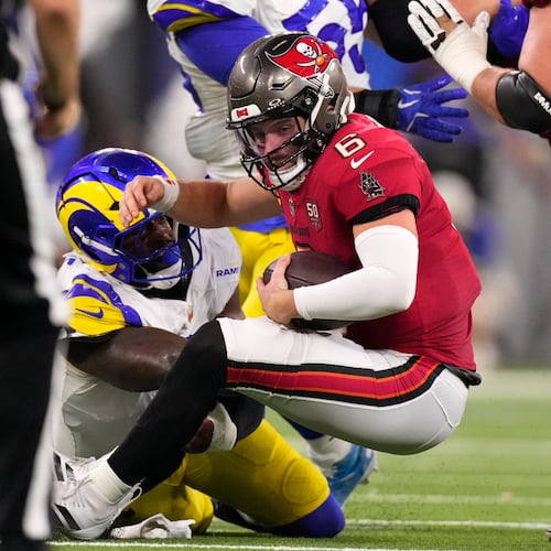 Los Angeles Rams linebacker Jared Verse tackles Tampa Bay Buccaneers quarterback Baker Mayfield during the first half of an NFL football game, Sunday, Nov. 23, 2025, in Inglewood, Calif. (AP Photo/Mark J. Terrill)