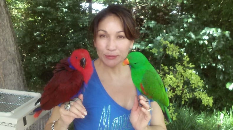 Frances Rodriguez with her two birds. Hoopidoopi (left) went missing last month.