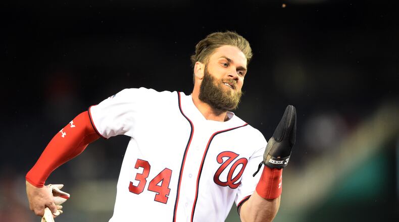 Bryce Harper rounds third and scores on Howie Kendrick's hit during the first inning. (Photo by Mitchell Layton/Getty Images)