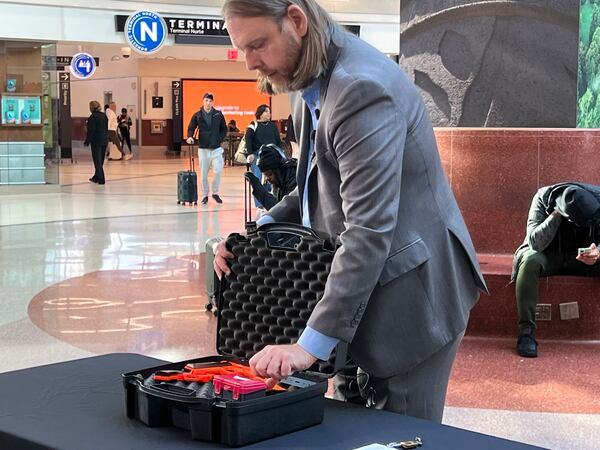 Transportation Security Administration spokesman Mark Howell at Hartsfield-Jackson International Airport on January 16, 2025 demonstrated the proper way to pack a firearm in checked luggage for travel. Kelly Yamanouchi/AJC