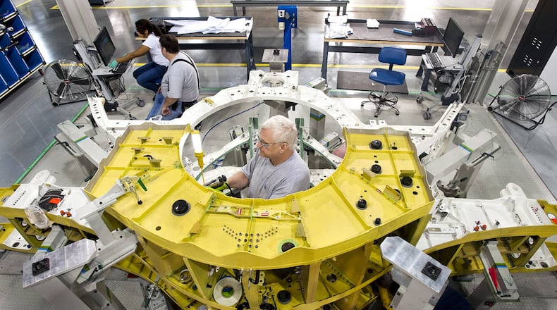 Lockheed Martin mechanics assemble components of an F-35 Joint Strike Fighter’s center wing in Marietta. A defense policy bill that the U.S. House approved Friday calls for adding 87 more of the planes to the military’s fleet. (Photo by John Rossino, Lockheed Martin Aeronautics Co.)