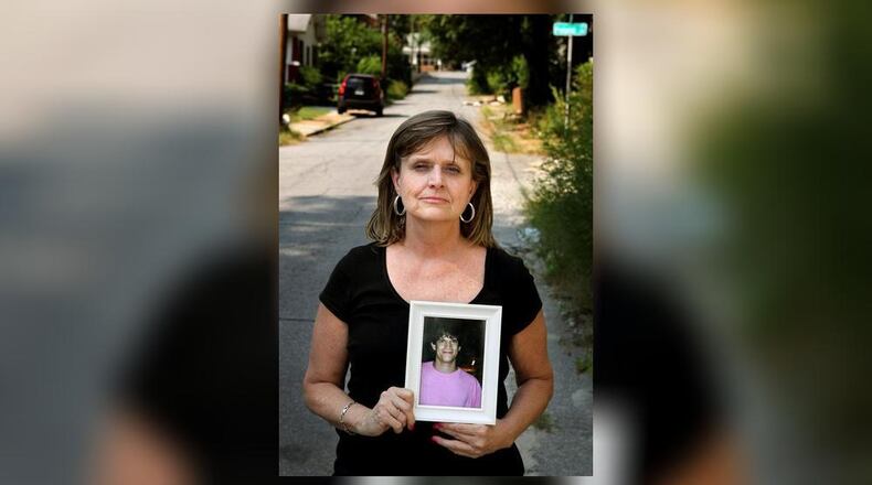 Robin Elliott holds a photograph of her late 21-year-old son, Zack Elliott, who was found dead in his automobile of a drug overdose in 2011. (AJC File Photo)