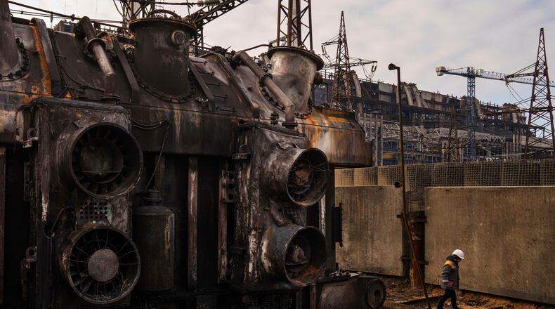 FILE - A worker walks in front of a transformer which was destroyed after a recent Russian missile attack at DTEK's power plant in Ukraine, Nov. 28, 2024. (AP Photo/Evgeniy Maloletka, file)