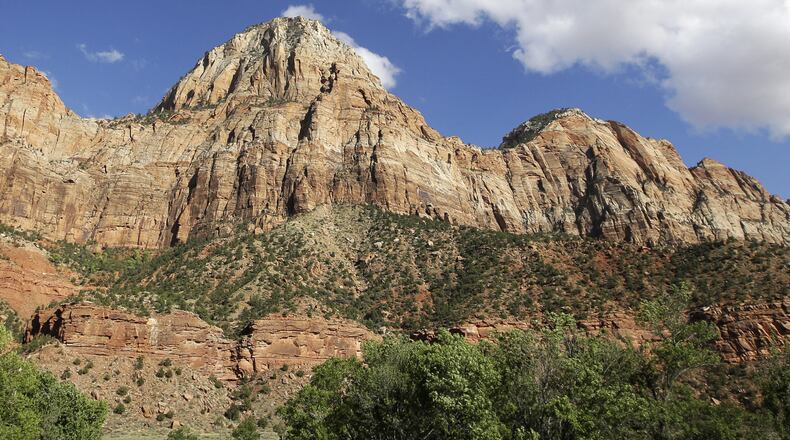 FILE - Sheer cliffs rise at Zion National Park, near Springdale, Utah., Sept. 16, 2015. (AP Photo/Rick Bowmer, File)