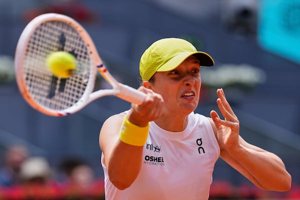 Iga Swiatek of Poland returns the ball against Russia's Diana Shnaider during the Madrid Open tennis tournament in Madrid, Spain, Tuesday, April 29, 2025. (AP Photo/Manu Fernandez)