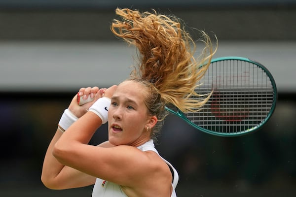 Mirra Andreeva of Russia returns to Emma Navarro of the U.S. during a fourth round women's singles match at the Wimbledon Tennis Championships in London, Monday, July 7, 2025. (AP Photo/Kin Cheung)