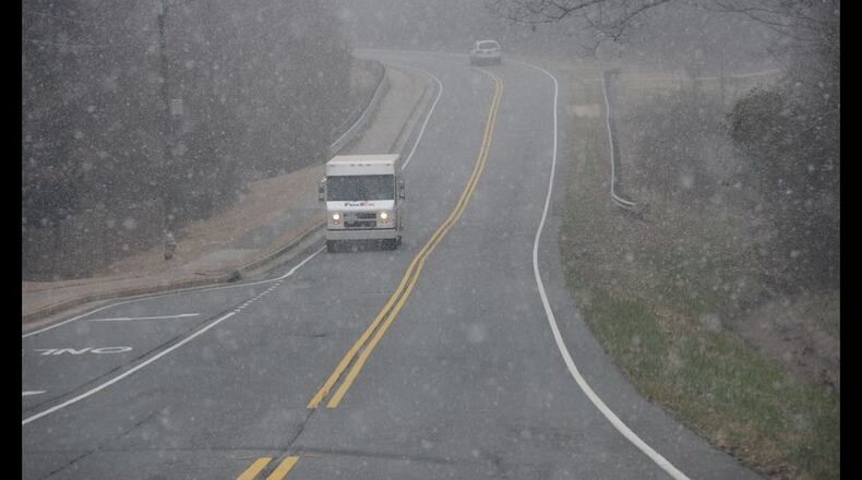Flurries on Tues., Feb. 9, 2016, did not stop people from hitting walking and running trails in Snellville in Gwinnett County. HYOSUB SHIN / HSHIN@AJC.COM