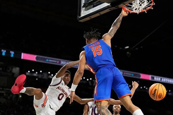 Florida guard Alijah Martin scores over Auburn guard Tahaad Pettiford during the second half in the national semifinals at the Final Four of the NCAA college basketball tournament, Saturday, April 5, 2025, in San Antonio. (AP Photo/Brynn Anderson)