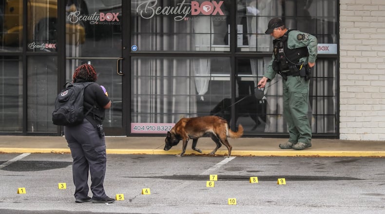 Atlanta police investigated in a parking lot at the corner of Marietta Boulevard and Coronet Way after a shooting involving a Brinks armored truck driver Tuesday morning.