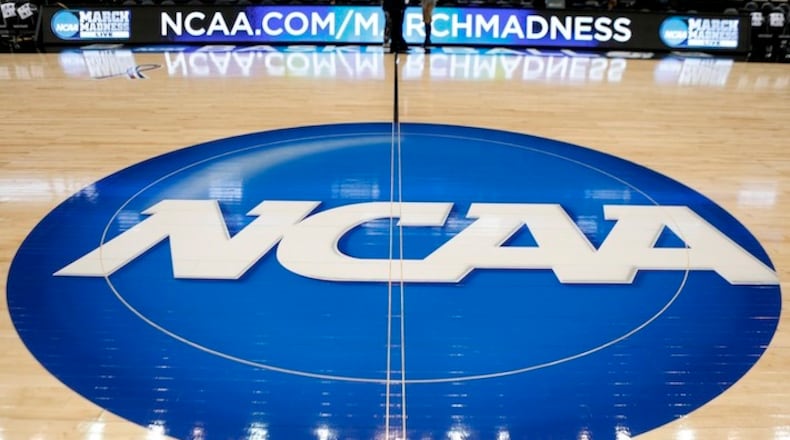 FILE - In this March 18, 2015, file photo, the NCAA logo is at center court as work continues at The Consol Energy Center in Pittsburgh, for the NCAA college basketball second and third round games. The NCAA is moving toward reforming transfer rules. There is much work to be done and any drastic changes are likely a few years away. New transfer rules will be rooted in academics, and could give higher achieving students more freedom while limiting who might be less likely to graduate if they switch schools.(AP Photo/Keith Srakocic, File)