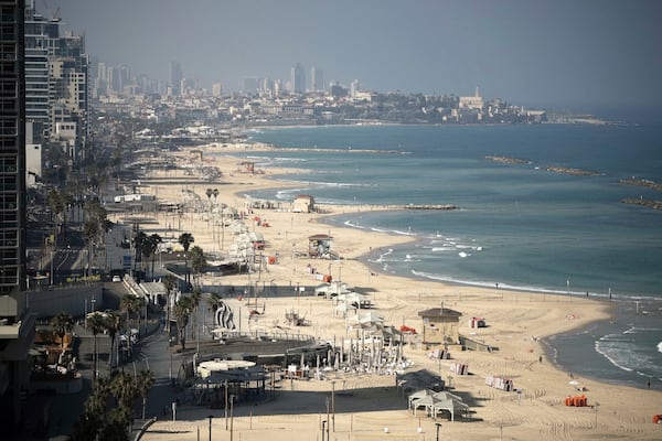 A general view shows the mostly empty beachfront in Tel Aviv, Friday, June 13, 2025. (AP Photo/Leo Correa)