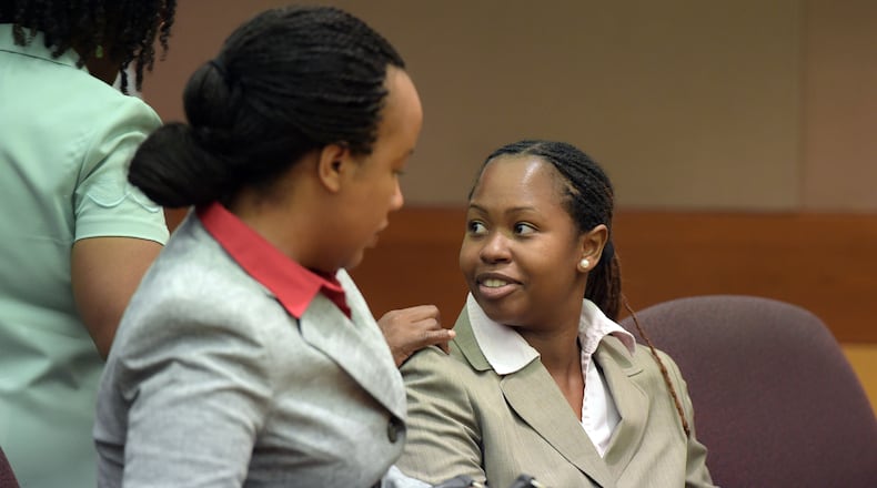 Former APS Dunbar Elementary teacher Shani Robinson gets support from her mother, Beverly Robinson, as she sits with her defense attorney Annette Greene, before the sentencing starts. Robinson, the final defendant in the Atlanta Public Schools test-cheating trial appeared for sentencing before Judge Jerry Baxter in Fulton County Superior Court, Tuesday, September 1, 2015.
