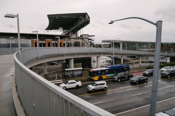 A King County Metro bus stops along a bus lane on Montlake Blvd NE outside of Sound Transit’s University of Washington station, on Monday, Dec. 15, 2025. (Ramon Dompor for the AJC)