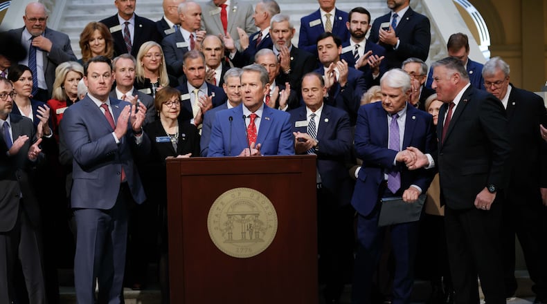 Lt. Gov. Burt Jones (from left), Gov. Brian Kemp, Speaker of the House Jon Burns and Insurance Commissioner John King applaud during a news conference related to Medicaid on Wednesday, Jan. 15, 2025, at the state Capitol in Atlanta. (Miguel Martinez/AJC)