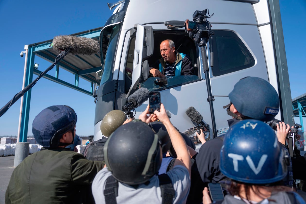 FILE - A truck driver picks up humanitarian aid designated for Gaza, as reporters tour the Palestinian side of the Kerem Shalom crossing where aid is awaiting pickup, on Dec. 19, 2024. (AP Photo/Ohad Zwigenberg, File)