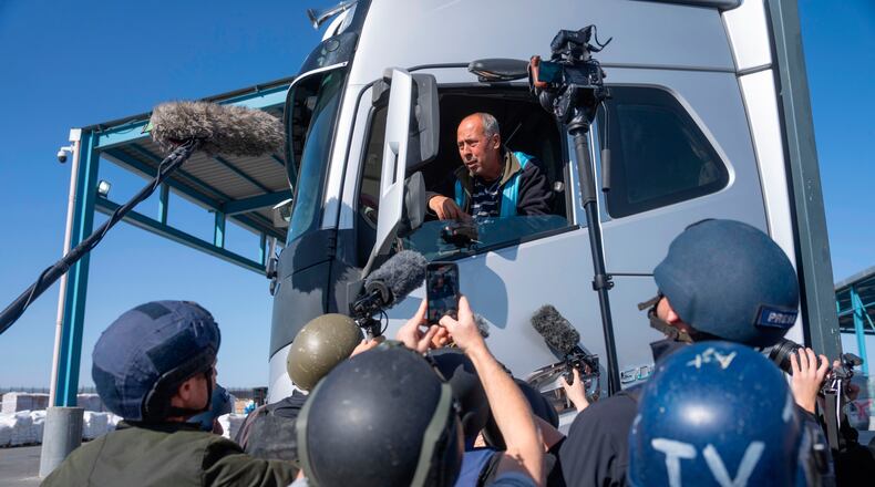 FILE - A truck driver picks up humanitarian aid designated for Gaza, as reporters tour the Palestinian side of the Kerem Shalom crossing where aid is awaiting pickup, on Dec. 19, 2024. (AP Photo/Ohad Zwigenberg, File)