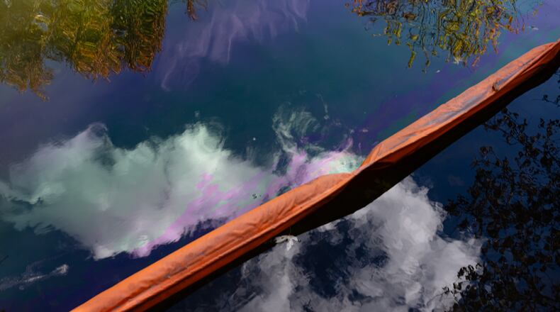 Oil runoff from the UPS plane crash is seen in a waterway known as Northern Ditch, Saturday, Nov. 8, 2025, in Louisville, Ky. (AP Photo/Jon Cherry)