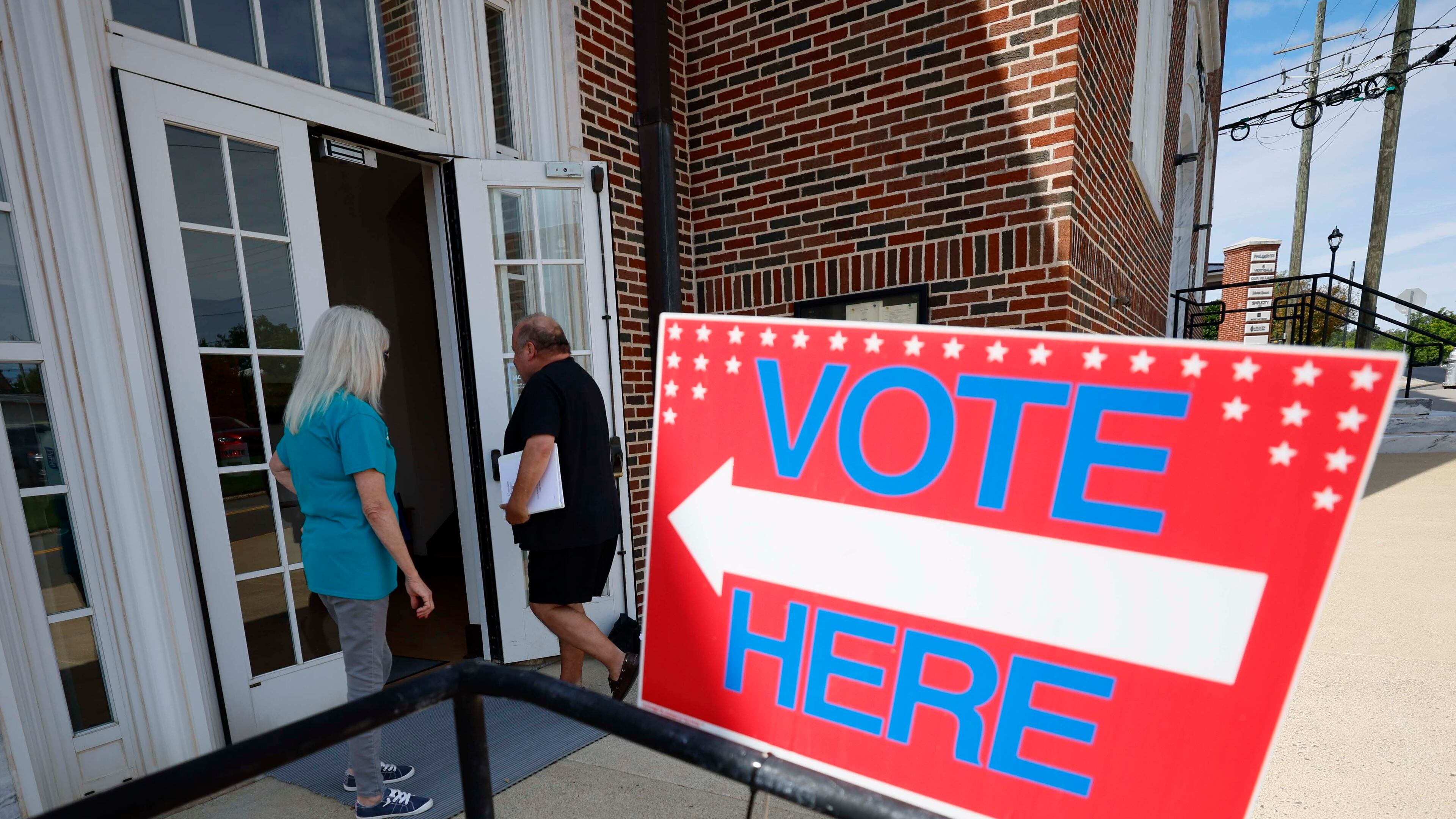 People are seen entering Canton City Hall to vote in August. (Miguel Martinez/AJC)