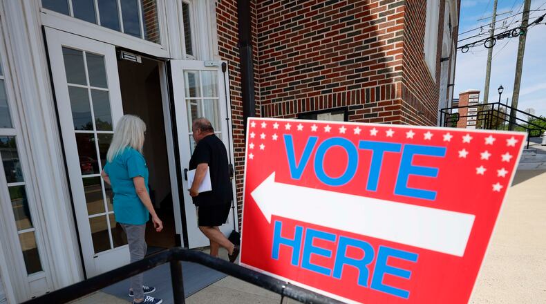 People are seen entering Canton City Hall to vote in August. (Miguel Martinez/AJC)