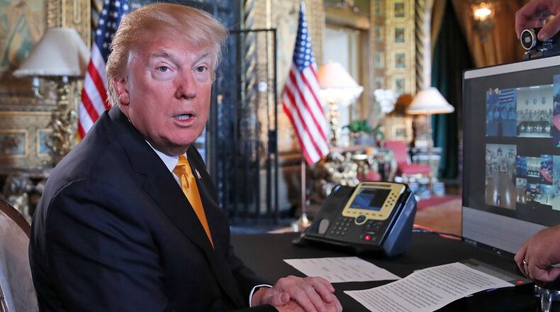 President Donald Trump speaks to the media before speaking with members of the armed forces via video conference at his private club, Mar-a-Lago, on Thanksgiving, Thursday, Nov. 23, 2017, in Palm Beach, Fla. (AP Photo/Alex Brandon)