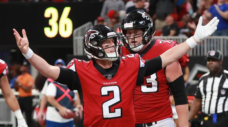 Atlanta Falcons quarterback Matt Ryan looks to the fans in celebration after scoring the game-winning touchdown on a quarterback keeper against the Carolina Panthers Sunday, Sept 16, 2018, at Mercedes-Benz Stadium in Atlanta.