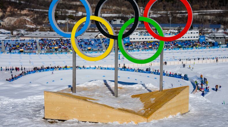 FILE - The Olympic rings stand above the course during the cross country skiing women's 50km mass start classic at the 2026 Winter Olympics, in Tesero, Italy, Feb. 22, 2026. (AP Photo/Matthias Schrader, File)
