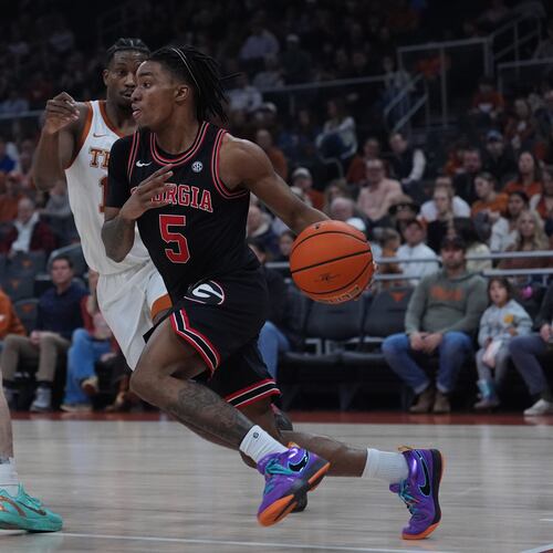 Georgia guard Jeremiah Wilkinson drives around Texas guard Tramon Mark during the first half of an NCAA college basketball game in Austin, Texas, Saturday, Jan. 24, 2026. (Eric Gay/AP)