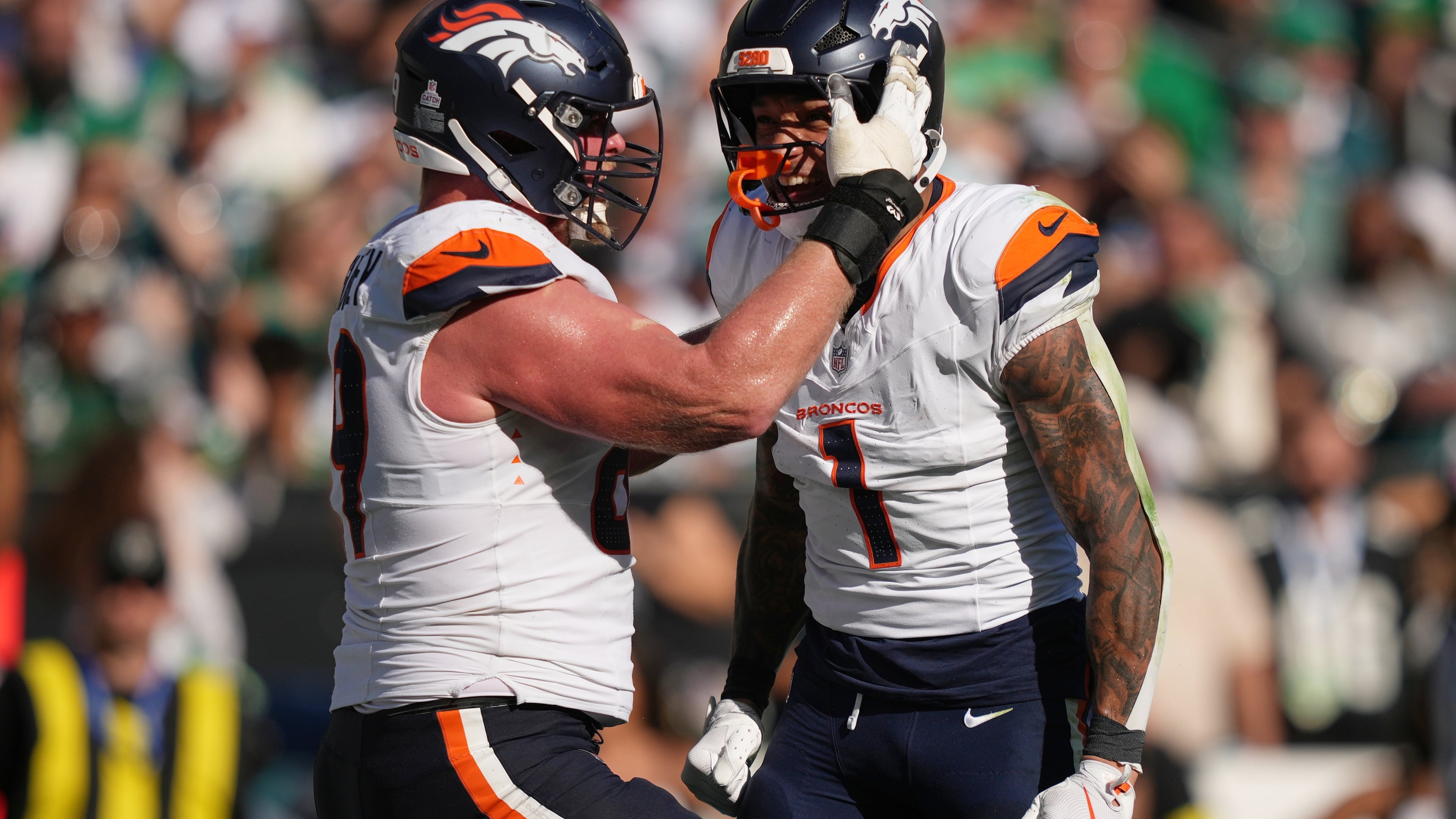 Denver Broncos tight end Evan Engram (1) celebrates his touchdown with Broncos offensive tackle Mike McGlinchey during the second half of an NFL football game against the Philadelphia Eagles on Sunday, Oct. 5, 2025, in Philadelphia. (AP Photo/Matt Slocum)