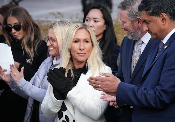 Rep. Marjorie Taylor-Greene, R-Ga., center, with Rep. Thomas Massie, R-Ky., second from right, and Rep. Ro Khanna, D-Calif., far right, applauds during a news conference as the House prepares to vote on the Epstein Files Transparency Act, at the Capitol in Washington, Tuesday, Nov. 18, 2025. (J. Scott Applewhite/AP)