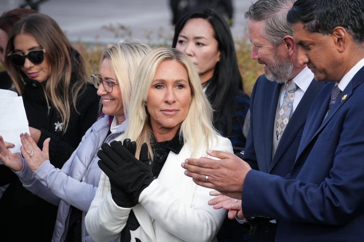 Rep. Marjorie Taylor-Greene, R-Ga., center, with Rep. Thomas Massie, R-Ky., second from right, and Rep. Ro Khanna, D-Calif., far right, applauds during a news conference as the House prepares to vote on the Epstein Files Transparency Act, at the Capitol in Washington, Tuesday, Nov. 18, 2025. (AP Photo/J. Scott Applewhite)