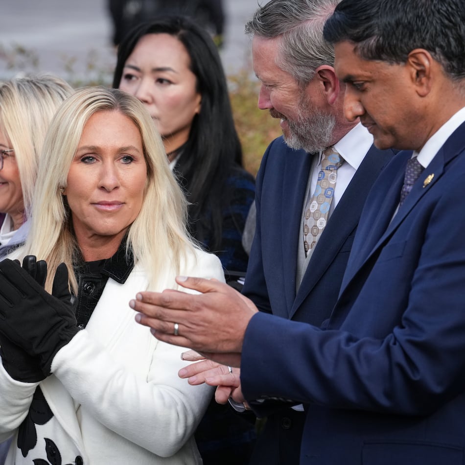 Rep. Marjorie Taylor-Greene, R-Ga., center, with Rep. Thomas Massie, R-Ky., second from right, and Rep. Ro Khanna, D-Calif., far right, applauds during a news conference as the House prepares to vote on the Epstein Files Transparency Act, at the Capitol in Washington, Tuesday, Nov. 18, 2025. (AP Photo/J. Scott Applewhite)