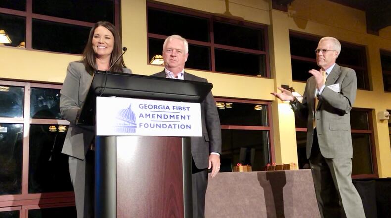 Misti Turnbull, the news director of Channel 2 Action News, left, announces an $80,000 donation by the television station and The Atlanta Journal-Constitution to the Georgia First Amendment Foundation. She was joined on stage by AJC Editor Kevin Riley, center, and foundation President Richard Griffiths. J. SCOTT TRUBEY/STRUBEY@AJC.COM.