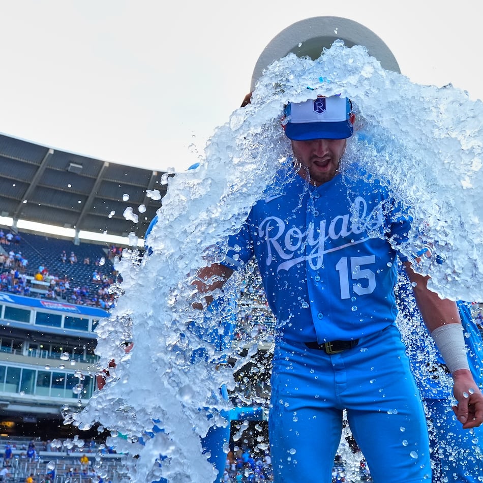 Kansas City Royals' Lane Thomas is doused by teammates after their baseball game against the San Diego Padres, Saturday, July 18, 2026, in Kansas City, Mo. (AP Photo/Charlie Riedel)