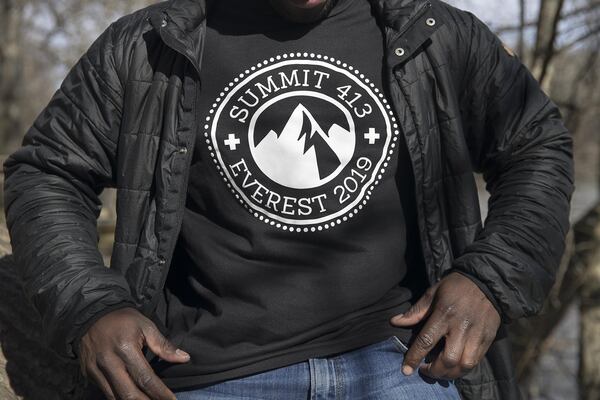 Jermaine Middleton shows off his branded “Summit 413” T-shirt at Cochran Shoals Unit along the Chattahoochee River in Marietta last week. The numbers in his logo design come from a Bible verse, Philippians 4:13, which reads, “I can do all things through Christ who strengthens me.” ALYSSA POINTER / ALYSSA.POINTER@AJC.COM