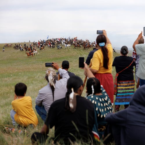 Spectators watch the charging event during festivities to commemorate the 150th anniversary of the Battle of the Little Bighorn in Crow Agency, Mont., on Thursday, June 25, 2026. (AP Photo/Tailyr Irvine)
