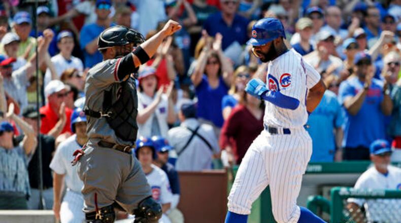 Chicago Cubs' Jason Heyward, right, scores on a double by Anthony Rizzo as Arizona Diamondbacks catcher Welington Castillo looks to the field during the sixth inning of a baseball game Friday, June 3, 2016, in Chicago. (AP Photo/Nam Y. Huh)