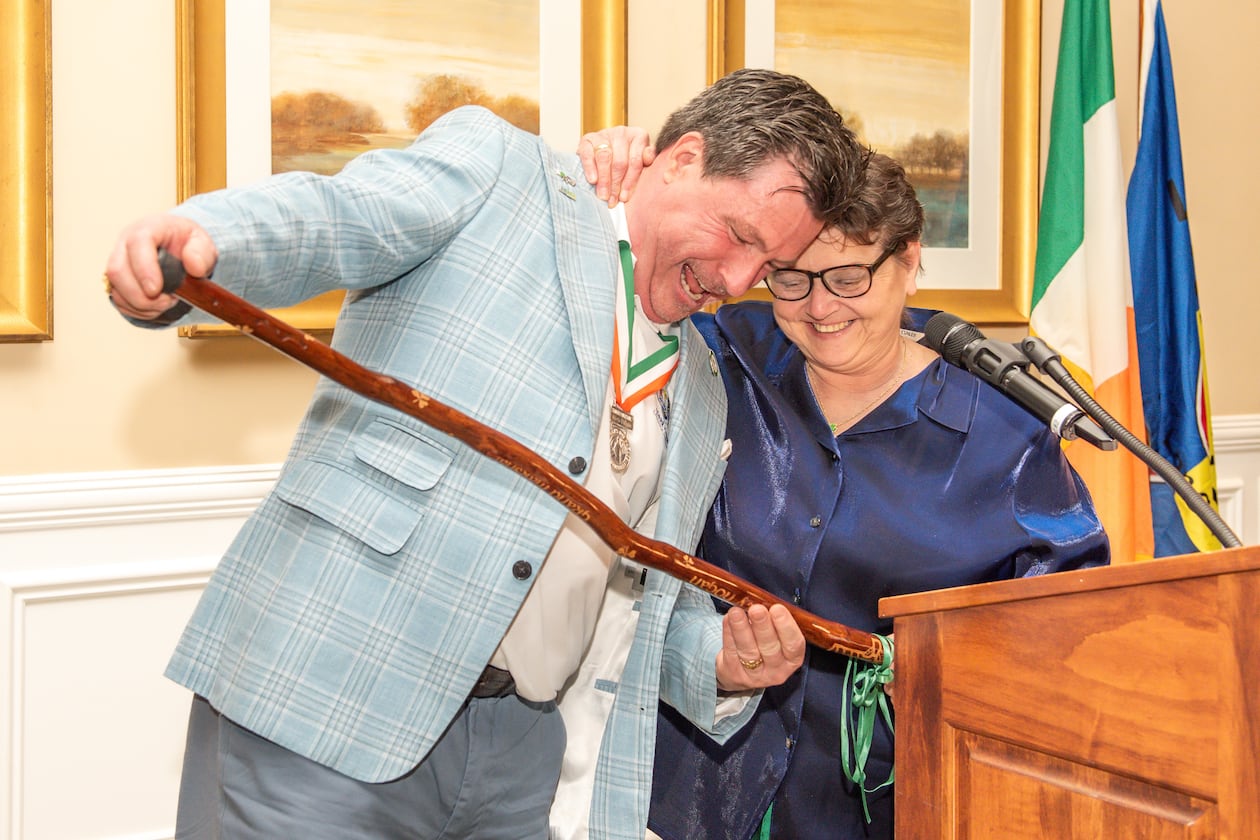 Wood carver Denise LeMay, right, presents a shillelagh, an Irish ceremonial walking stick, to Martin Hogan, the grand marshal of the Savannah St. Patrick’s Day Parade, at a ceremony in Savannah, Georgia on Tuesday, March 3, 2026. The annual parade is March 17 and LeMay has carved shillelaghs for its grand marshals for 22 years. (Kaitlin Sells)